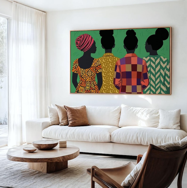 May include: A rectangular wall art print featuring four figures seen from behind against a solid green background. The figures wear patterned tops in orange, yellow, red, and green, with distinct hairstyles including a headwrap and buns.