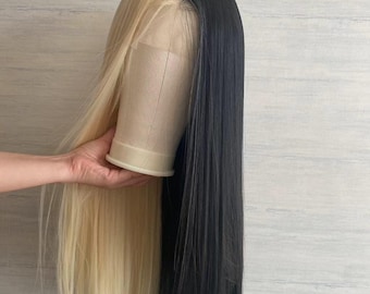 May include: A long, straight wig with half blonde and half black hair. The wig is on a mannequin head.