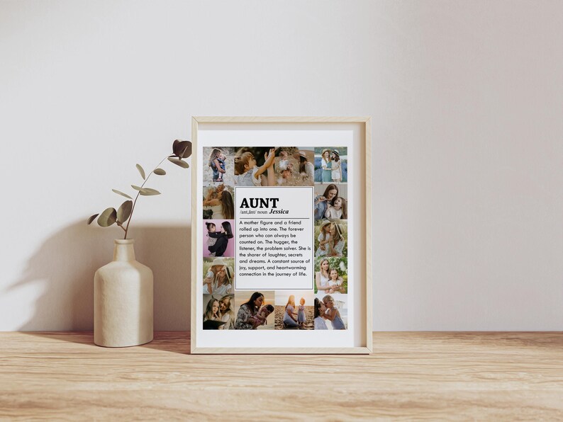 May include: A framed print with a collage of photos of a woman and her family. The print has a black and white design with the word "AUNT" and the name "Jessica" in bold text. The text below the title defines the word "aunt" as a mother figure and a friend.