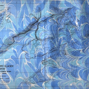 May include: A black and white map of Otto Fiord Glacier in Northern Ellesmere Island, Canada. The map shows the glacier's contours and features a blue and white marbled background.