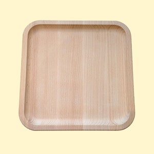 May include: A light brown wooden serving tray with rounded edges and a smooth surface.