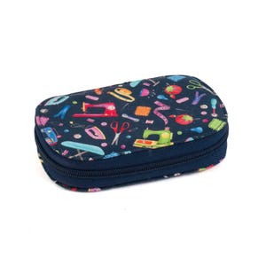 May include: A navy blue, zipped sewing kit case with a colourful pattern of sewing tools. The pattern includes sewing machines, scissors, and measuring tapes. The case is rectangular with rounded edges.