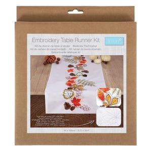 May include: A boxed embroidery table runner kit. The kit features a white table runner with a fall leaf design, measuring 40 x 100cm. The box has text in multiple languages, including "Embroidery Table Runner Kit."