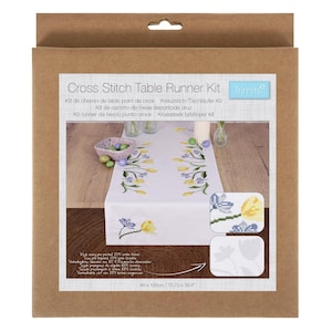 May include: A cross stitch table runner kit in a cardboard box. The kit includes a white table runner with a floral design, and two smaller cross-stitch examples. The table runner measures 40 x 100cm.