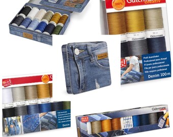 May include: A collection of sewing supplies, including spools of thread in various colors, needles, and a denim-themed box. The image also features several packages of Gütermann thread, showcasing a range of colors suitable for denim projects.