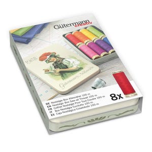 May include: A sewing kit box with a vintage design. The box features a colorful illustration of a woman and a tray of colorful thread spools. The box also includes a thimble and a spool of red thread. The text "Gütermann" is visible.