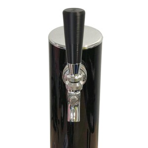 May include: A black beer tap with a chrome finish and a black handle. The tap is cylindrical with a silver top and a shiny black finish. The handle is a dark, textured black.