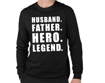 May include: Black long-sleeve shirt with the words "HUSBAND. FATHER. HERO. LEGEND." printed in white. The shirt is made of a soft material and has a crew neck.
