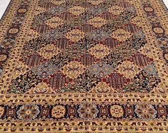 May include: A traditional Persian rug with a dark blue background and intricate floral patterns in shades of red, gold, and cream. The rug has a border with a repeating geometric design.