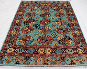 May include: A teal blue rug with a traditional Persian design. The rug has a central medallion with intricate floral patterns and a border with geometric motifs. The colors are vibrant and include shades of red, yellow, and blue.