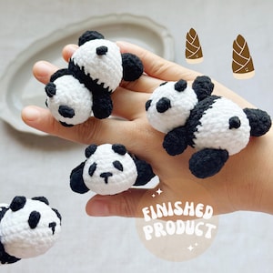 May include: Crocheted panda bear rings in black and white. The rings are handmade and feature a panda bear design. The image also includes two cartoon bamboo shoots and the text "FINISHED PRODUCT".