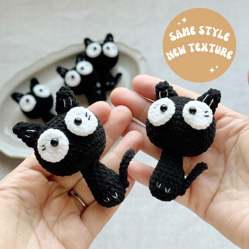 May include: Crocheted black cat figurines with white eyes and accents. The image shows several cat figures, some held in hands, and others on a plate. The text in the image says "SAME STYLE NEW TEXTURE".