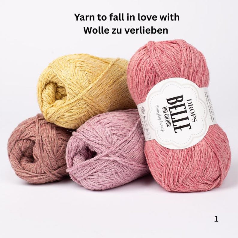 May include: A collection of colorful yarn balls in shades of pink, yellow, and mauve. One ball has a label that reads "BELLE UNI COLOUR Everyday Luxury DROPS". The text "Yarn to fall in love with Wolle zu verlieben" is at the top.