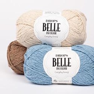 May include: Three skeins of Drops Belle Uni Colour yarn in cream, light blue, and brown. Each skein has a label with the brand name and product details. The yarn is tightly wound, showing a textured surface.
