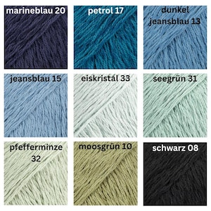 May include: Nine skeins of yarn in various colors, including navy blue, teal, light blue, and black. Each skein is labeled with a color name and number. The yarn appears to be a soft, textured material, suitable for knitting or crochet projects.