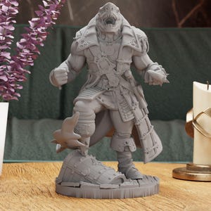 May include: A gray 3D printed figurine of a shark-like creature wearing a pirate costume. The creature is standing on a treasure chest with its mouth open and teeth showing. The figurine is on a gray wooden surface.