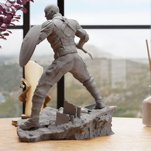 a statue of a man holding a shield on a table