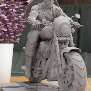 a statue of a man riding a motorcycle