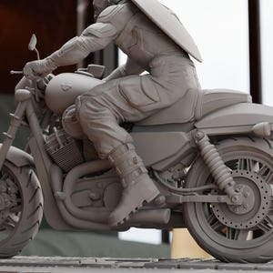 a statue of a man riding a motorcycle