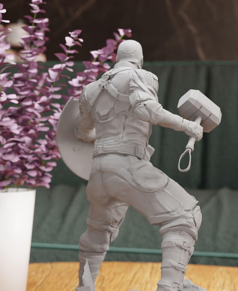 a statue of a man holding a pair of dumbs