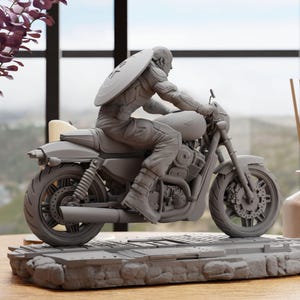 a statue of a man riding a motorcycle
