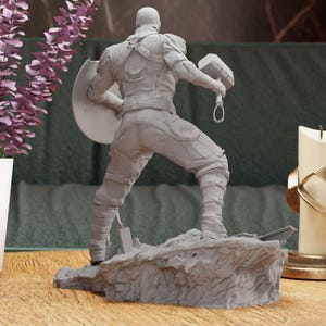a statue of a man holding a sword and shield