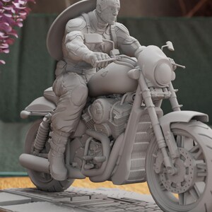 a statue of a man riding a motorcycle