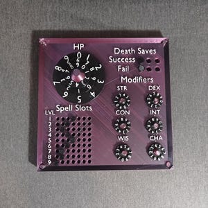 May include: A purple and black plastic character sheet for a tabletop role-playing game. The sheet has a dial for hit points, a section for spell slots, and a section for death saves. There are also dials for ability scores, including strength, dexterity, constitution, intelligence, wisdom, and charisma.