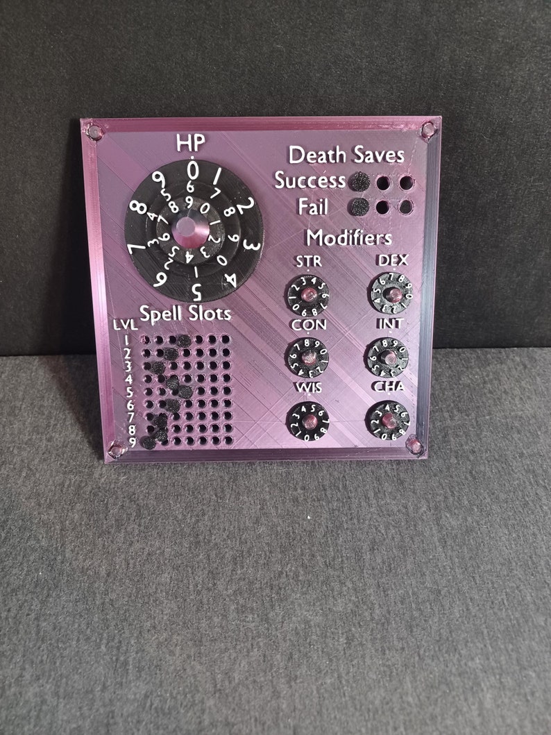 May include: A purple plastic character sheet with a rotating dial for hit points, a grid for spell slots, and dials for ability scores and death saves. The dials are black with white numbers.