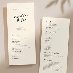 May include: Two ivory wedding programs with black calligraphy text. The left program reads "Kristin & Jed" and lists ceremony details. The right program lists family and wedding party members. A shadow of leaves is cast across the programs.