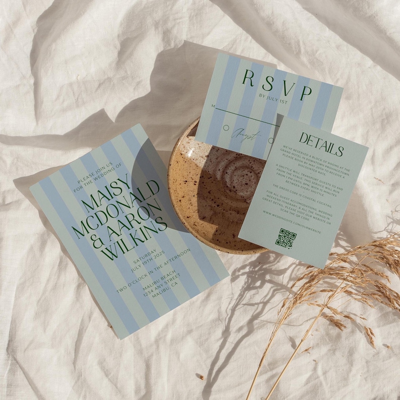 A wedding stationary set, including an invitation, details card, and rsvp card. The design features a two-toned striped background, in soft blues and greens. The fonts look modern and sleek. The vibe is playful, whimsical and beachy.
