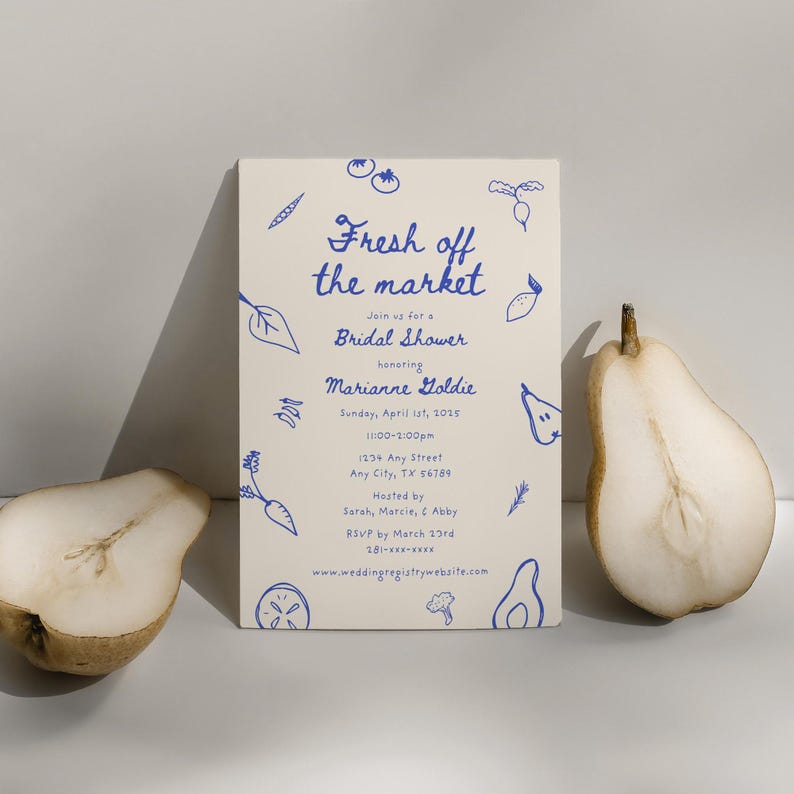 May include: A cream-colored invitation card with blue text and illustrations of vegetables and fruits. The text reads "Fresh off the market" and "Join us for a Bridal Shower honoring Marianne Goldie". The invitation includes the date, time, address, and RSVP information.