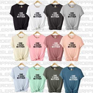 May include: Nine t-shirts in different colors with the text "One Tough Mother" printed in black on the front.