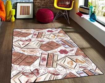 May include: A white area rug with a pattern of open books, butterflies, and floral accents. The rug has a brown border and is on a wooden floor.