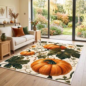 May include: A rectangular area rug featuring a repeating botanical pattern of large orange pumpkins, dark green leaves, and thin winding vines on a cream-colored background. The design covers the entire surface of the floor covering.
