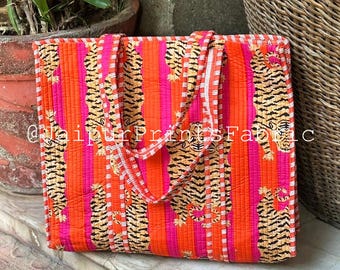 May include: Quilted tote bag with a vibrant tiger stripe pattern in orange, pink, and black. The bag has a rectangular shape with matching handles and a white trim. The text "@jaipurPrintsFabric" is visible.
