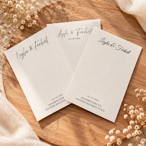May include: Three rectangular white paper cards featuring the black printed names Leyla & Ferhat in a script font, the date 10 | 10 | 2026, and the Turkish text HATIRIMIZ KIRK YIL, SEVGİMİZ BİR ÖMÜR OLSUN printed in a clean serif typeface.