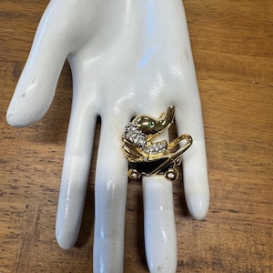 Vintage 80s 90s gold rhinestone and enamel baby elephant in baby carriage brooch pin