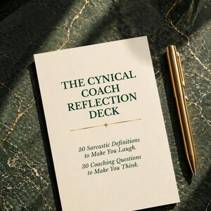 May include: A deck of cards titled "THE CYNICAL COACH REFLECTION DECK" with text that reads "30 Sarcastic Definitions to Make You Laugh" and "30 Coaching Questions to Make You Think." A gold pen rests beside the deck on a dark green marble surface.