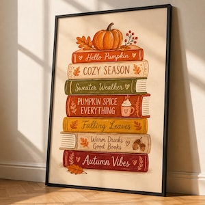May include: A framed vertical art print featuring a stack of seven books topped with an orange pumpkin. The book spines display the text: Hello Pumpkin, COZY SEASON, Sweater Weather, PUMPKIN SPICE EVERYTHING, Falling Leaves, Warm Drinks Good Books, and Autumn Vibes.