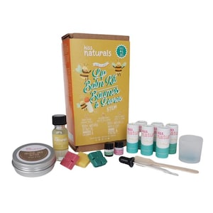 May include: A lip balm kit with a box that reads "kiss naturals Lip Balm Kit Baumes a Lèvres STEM". The kit includes lip balm tubes, essential oils, a small jar of shea butter, wax blocks, and a dropper. The box features bee illustrations.