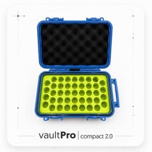 May include: A blue hard-shell storage case with a hinged lid, featuring black egg-crate foam in the top and a bright lime green foam insert with forty-eight circular cutouts in the base. The text vaultPro compact 2.0 is printed below the case.