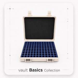 May include: A beige rectangular storage case with two top latches and two front latches. The interior features a black foam lid liner and a blue foam base with a grid of one hundred circular cutouts. The text vault Basics Collection is below.