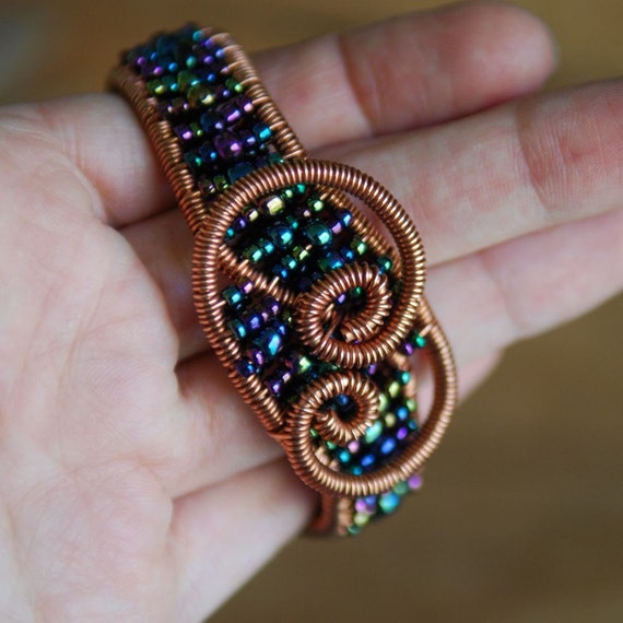 Items similar to Artisan Copper Swirls Cuff with Peacock Beads on Etsy