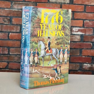 May include: A hardcover book titled 1776 Year of Illusions by Thomas Fleming. The dust jacket features a colorful illustration of a soldier on a white horse surrounded by infantrymen in blue uniforms, with dogs in the foreground and a forest background.