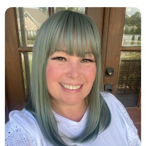 Gray silver straight synthetic wig with subtle blue highlights and bangs