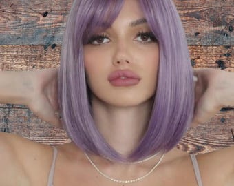 May include: A purple bob wig with a side-swept fringe. The wig is styled in a straight, blunt cut.