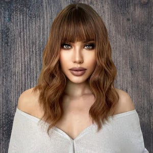 Medium length wavy brown reddish wig with bangs