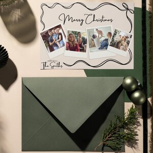 May include: A Christmas card with a green envelope. The card has a white background with a black border and a handwritten message that says "Merry Christmas". There are four photos on the card, each with a white border. The photos show a family celebrating Christmas. The card also has the text "With love, The Smiths".