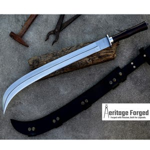 May include: A large, curved blade sword with a black handle and a silver blade, resting on a wooden plank. A black leather sheath is next to the sword. The image also shows a hammer, pliers, and the text "Aeritage Forged".